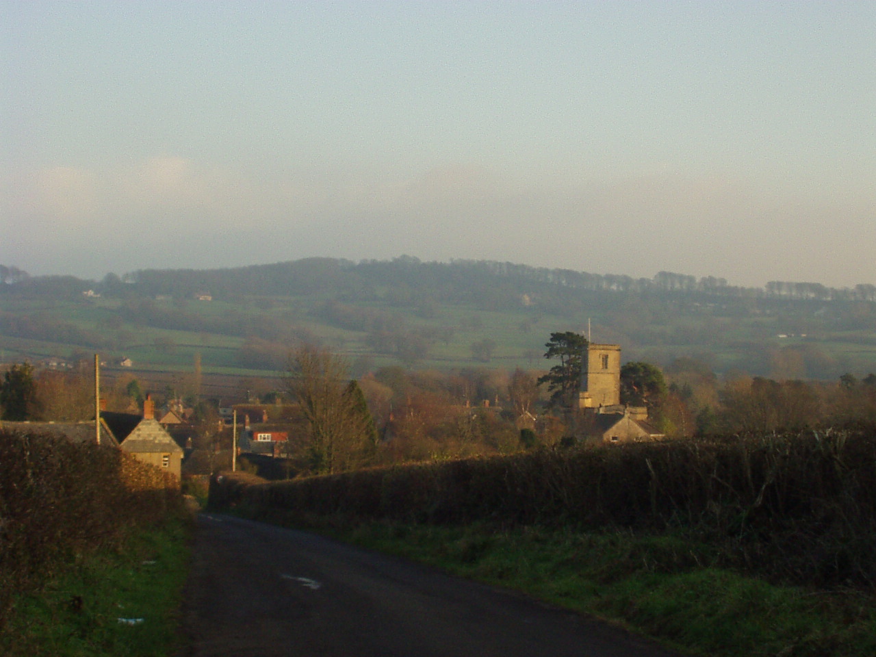 Looking down into the village we lived in South Perrott, Dorset with the village of Chedington high in the distance. The tiny white spec on the top left of the picture is Wynyards Gap Pub. Looking down into the village we lived in South Perrott, Dorset with the village of Chedington high in the distance. The tiny white spec on the top left of the picture is Wynyards Gap Pub.